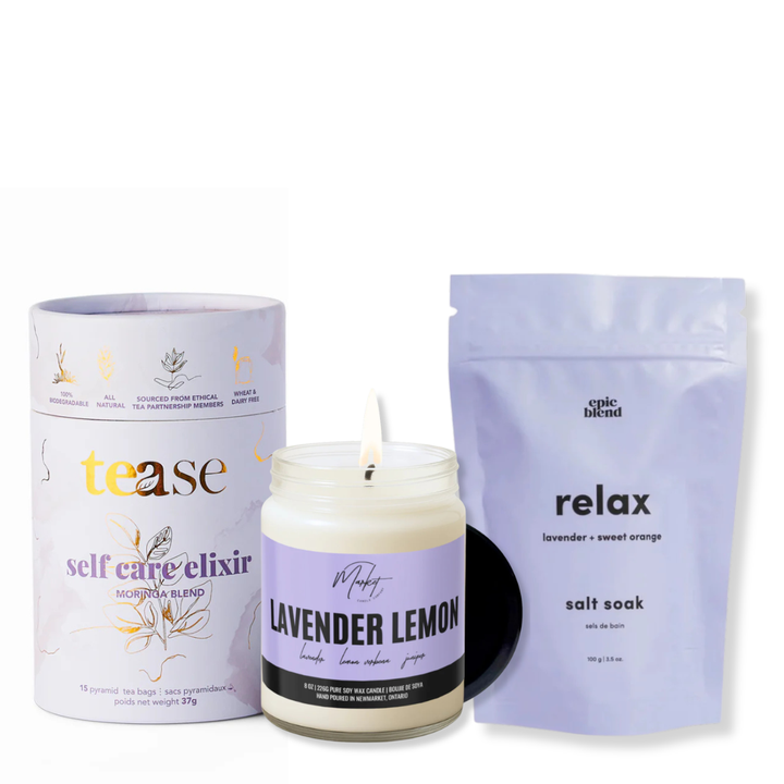 Three self-care products including a candle, a tube, and a bag on a white background