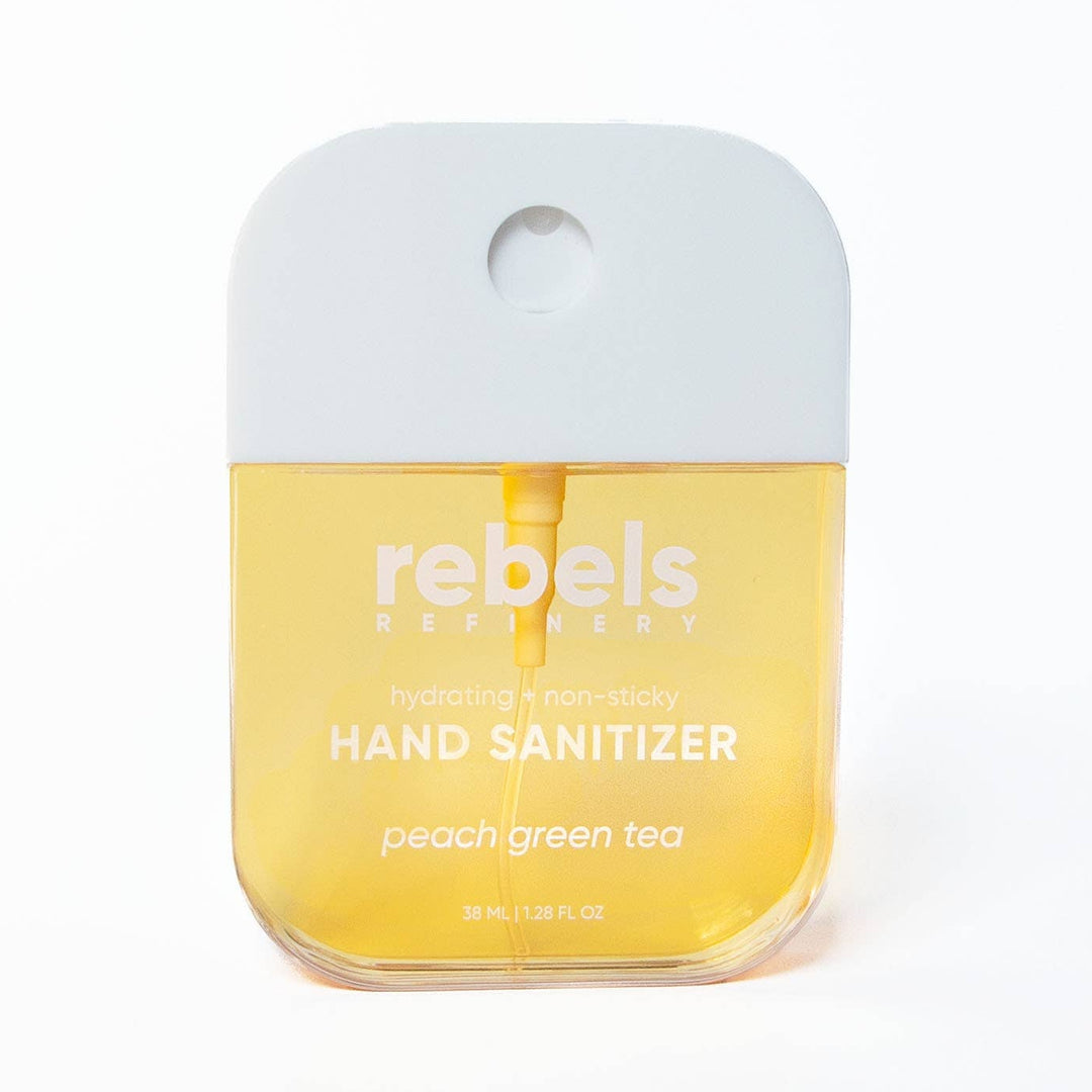 A bottle of Rebels Reproscents hand sanitizer in the peach green tea scent, featuring a translucent yellow liquid inside a clear bottle with a light gray cap, set against a plain white background.