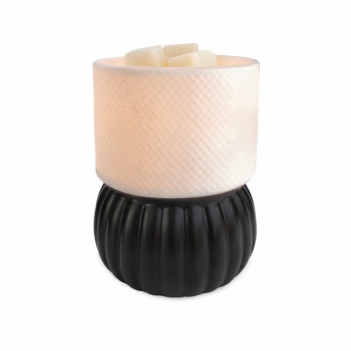 Candle in a black and white textured holder on a white background